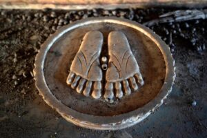 Resurfaced Charan Paduka from a Jain Derasar_ temple submerged in the Sardar Sarovar Dam waters in village Nisarpur, Madhya Pradesh, after the reservoir waters recede in summer, Photo Credit_ Rohit Jain for Oral History Narmada