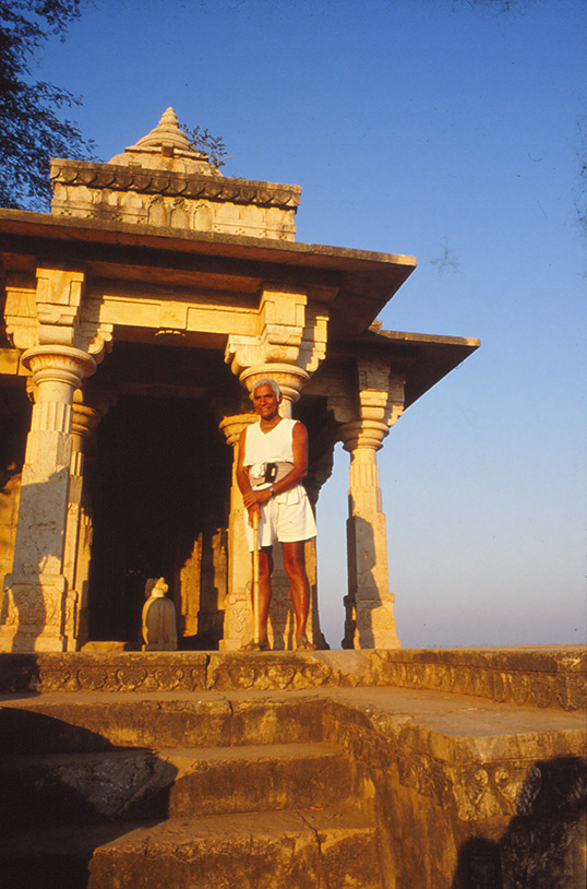 Baba Amte standing at a temple in the Kasravad village